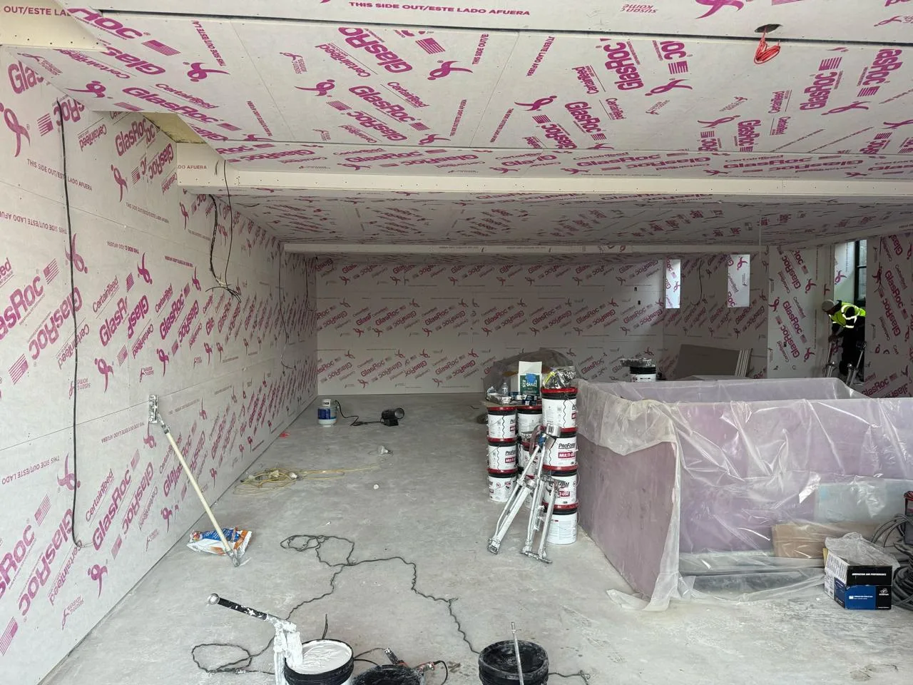 Drywall skim coating applied evenly to the room's walls.